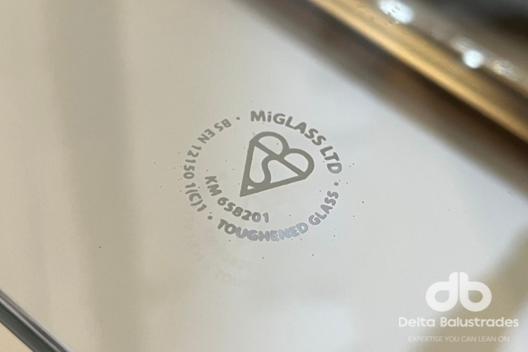 The safety stamp and kitemark logo on a glass panel balustrade infill